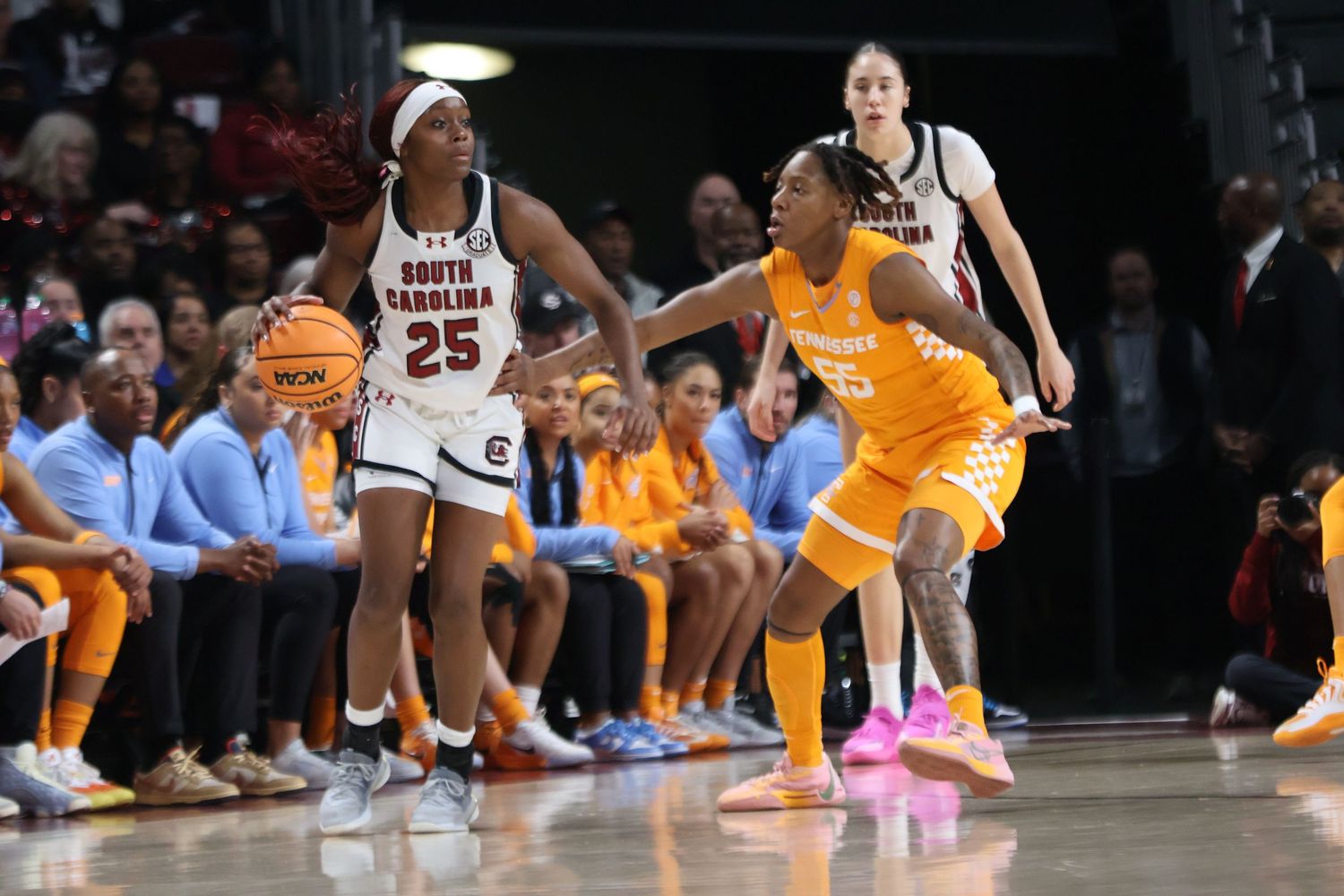 South Carolina basketball player wearing number 25 protects the ball from a Tennessee defender.