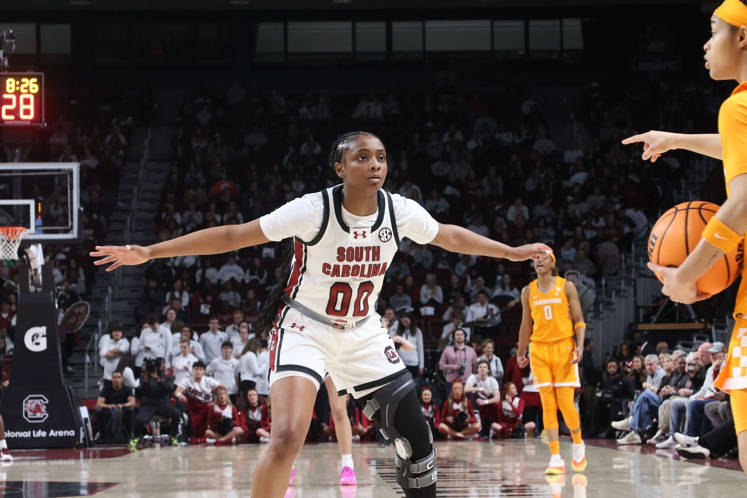 South Carolina basketball defender wearing number 00 spreads her arms to guard the ball handler.