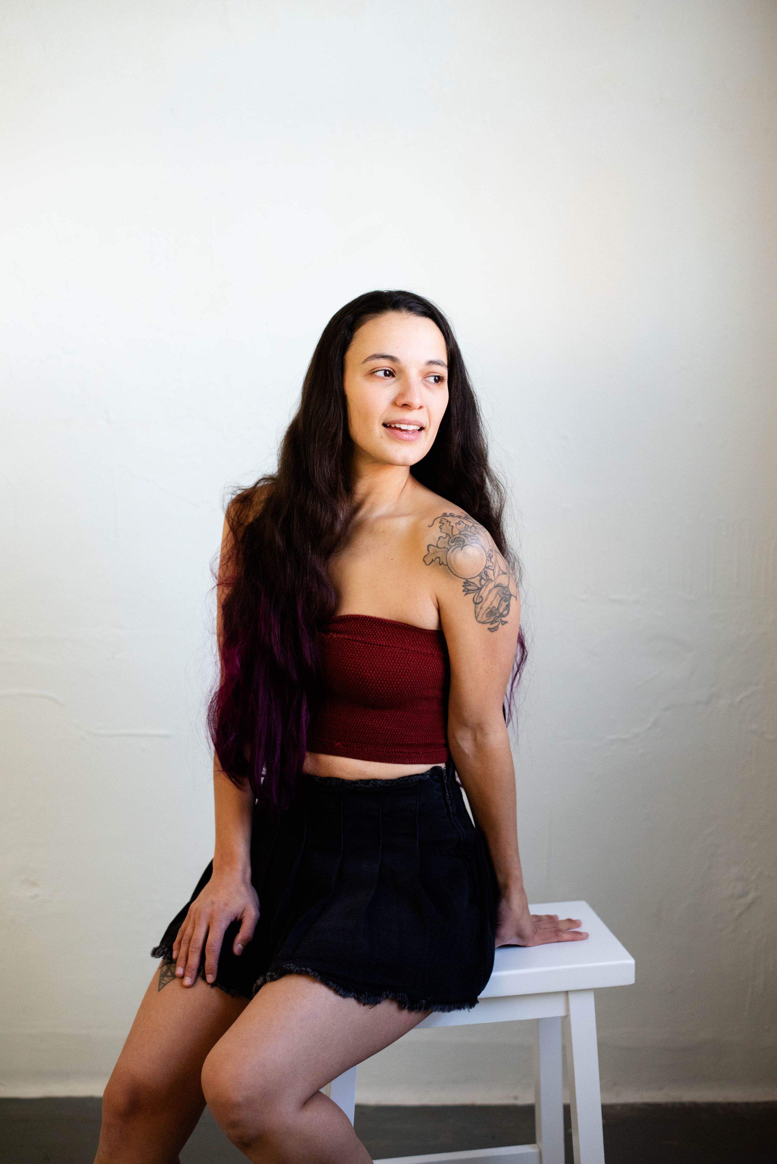 Inclusive boudoir photography in Rochester NY client sits on stool