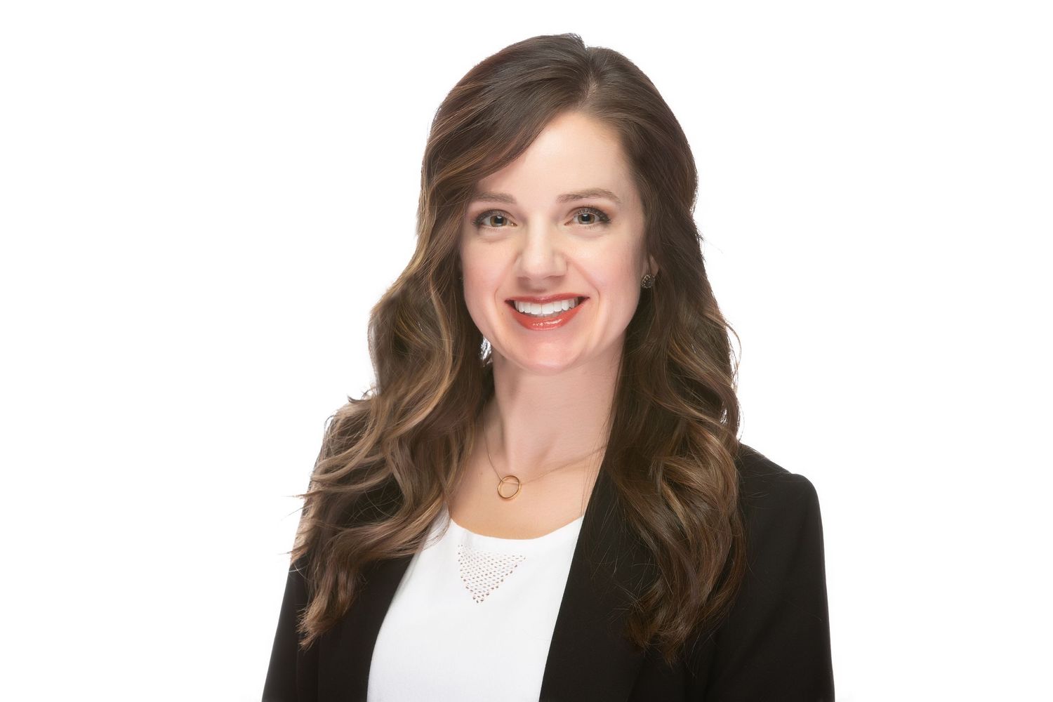 Warm and approachable portrait of a female professional smiling at the camera