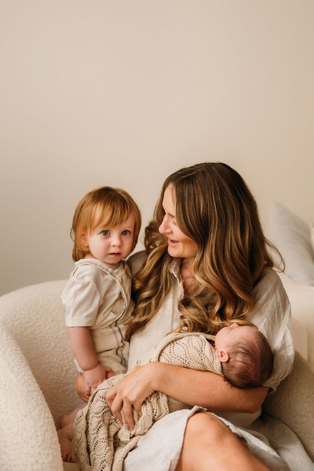 Brother meeting newborn baby during lifestyle newborn session