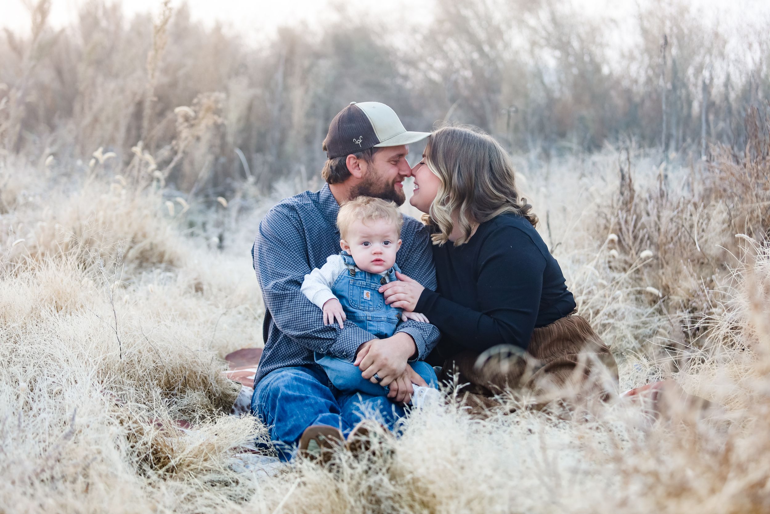 A series of intimate outdoor family portraits taken in tall grass and natural light.