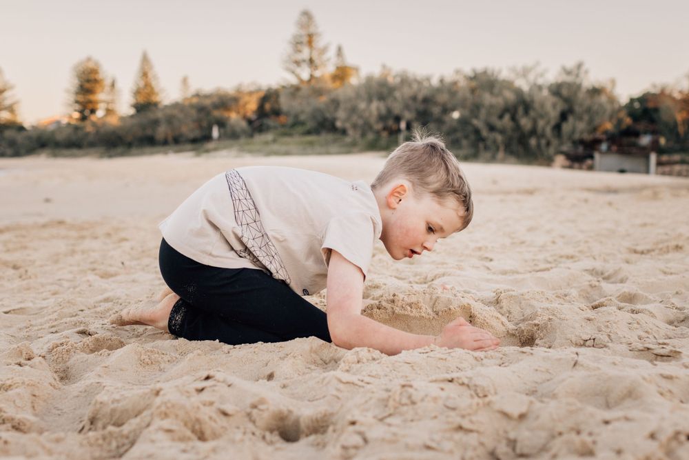 Relaxed beachside photos with pine trees in background during golden hour.