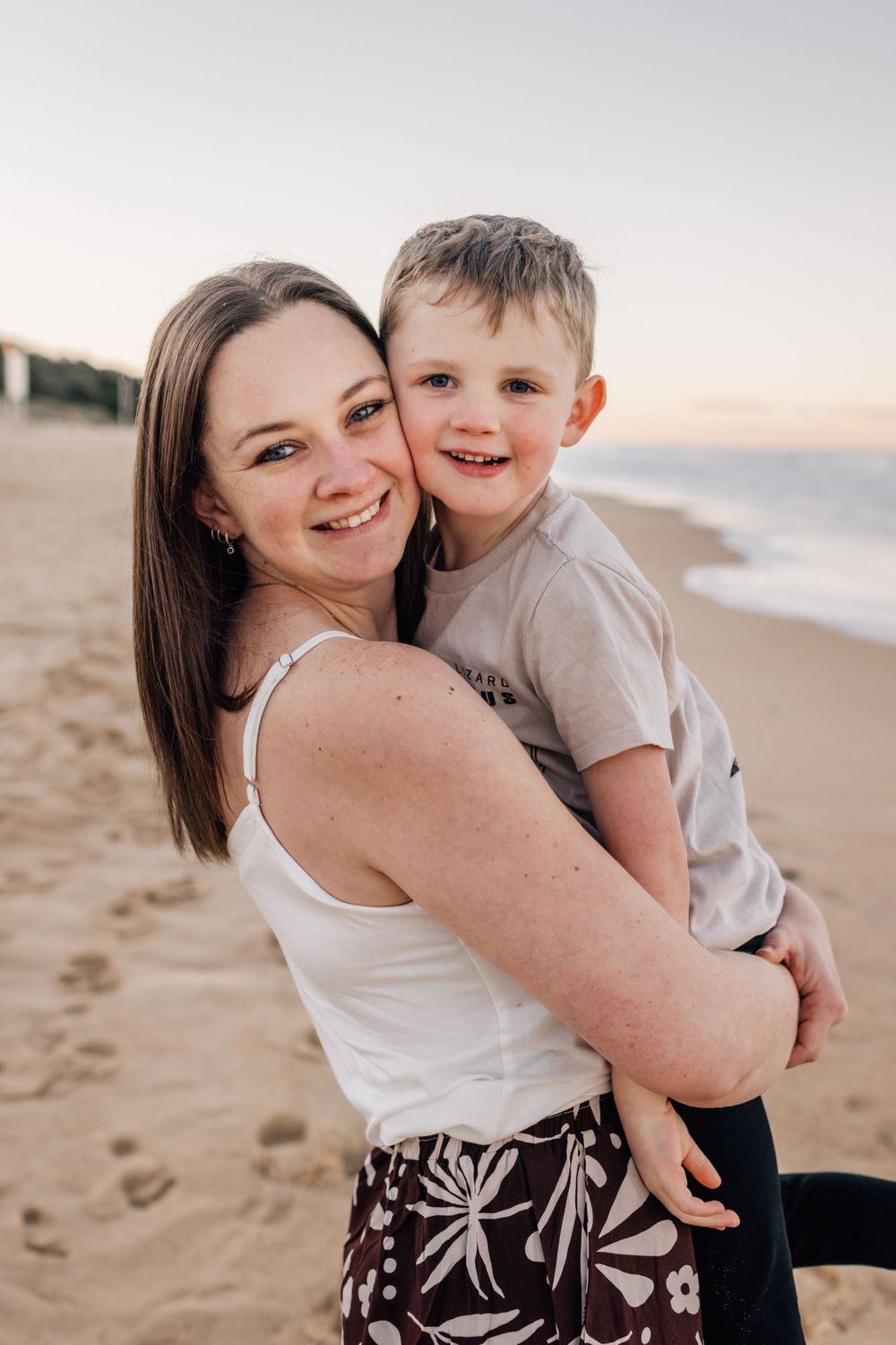 Joyful candid portraits capturing laughter and embraces on a sunny beach.