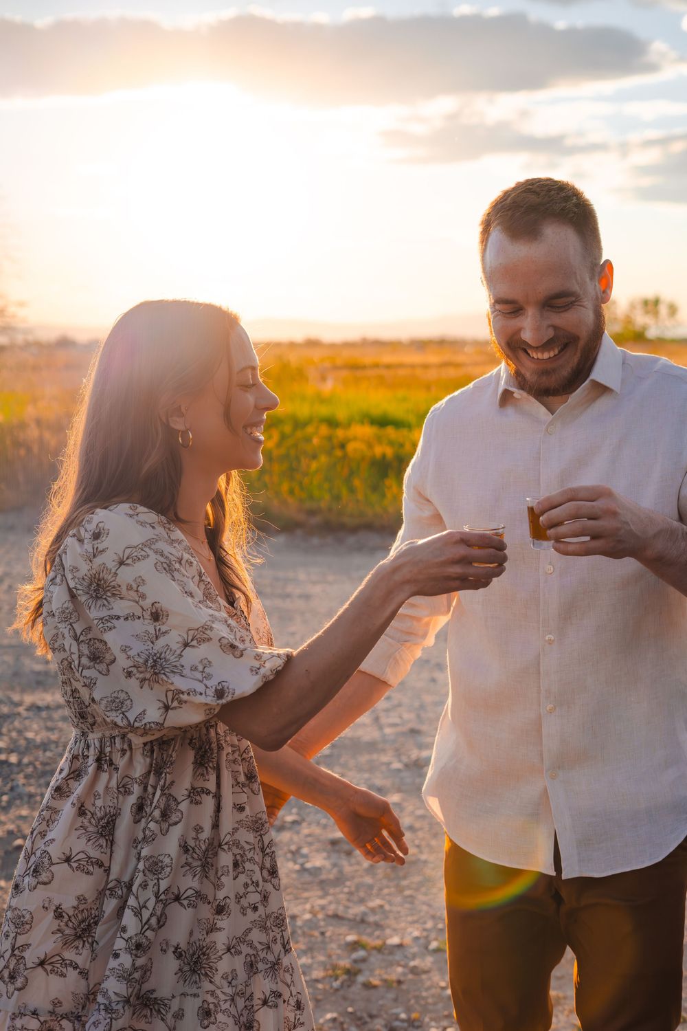 A romantic golden hour photo sequence of a couple sharing playful moments in a wild flower field at sunset.