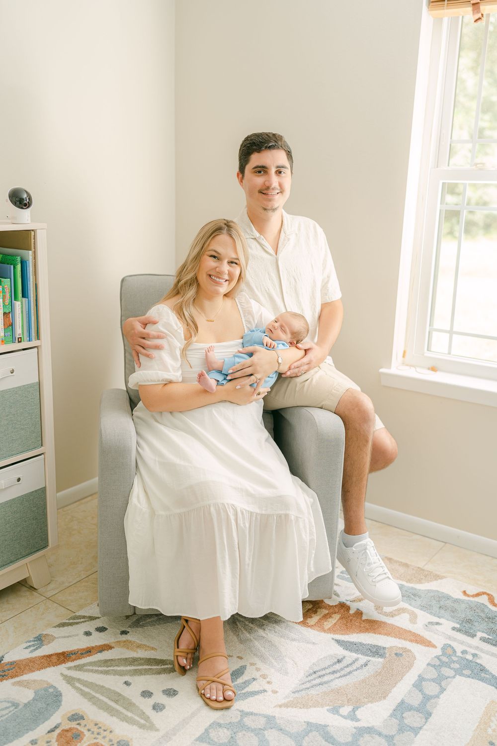 Lifestyle photos show a cozy moment on a blue and white patterned rug in a bright white room with natural lighting.