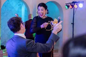 Singer of Ronna and the Copycats interacting with audience at a Summerhouse Houston gala at The Bell Tower on 34th in Houston.