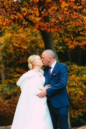 Autumn colours bride and groom kiss Epping Forest Essex