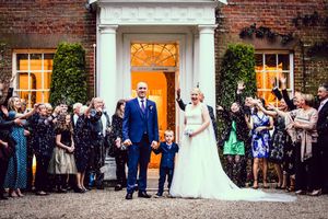 Family wedding formal photograph at the from of Mulberry House Wedding venue Essex