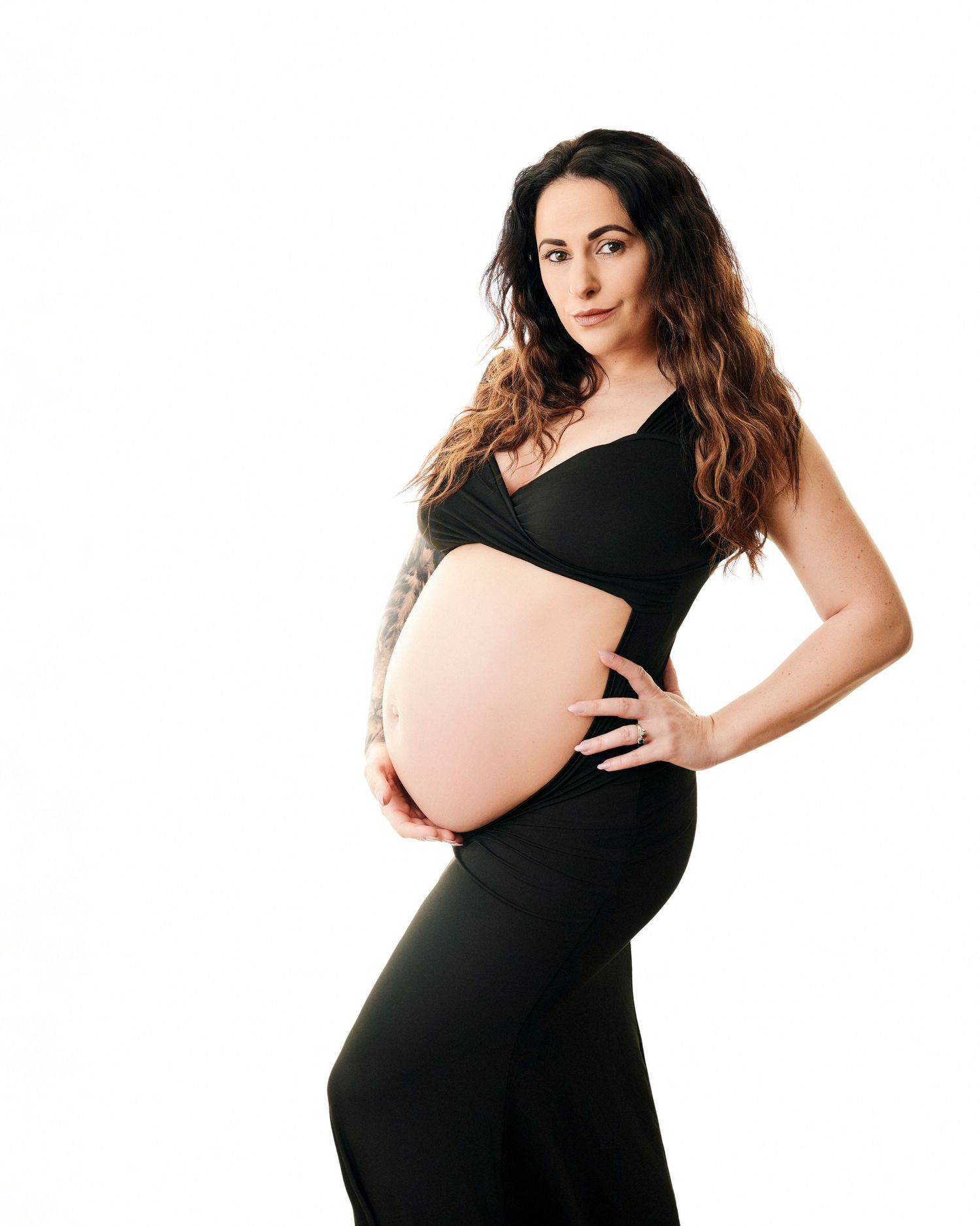 Pregnant woman in black maternity dress during her maternity session in Gloucester.