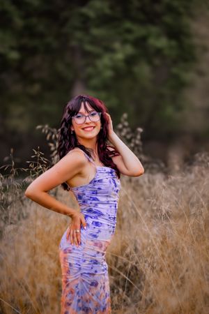 Poised and ready, young woman poses in a field of tall grass