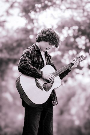senior boy photography boy strums a guitar