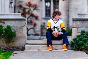 senior boy photography boy poses in his hockey team's jersey