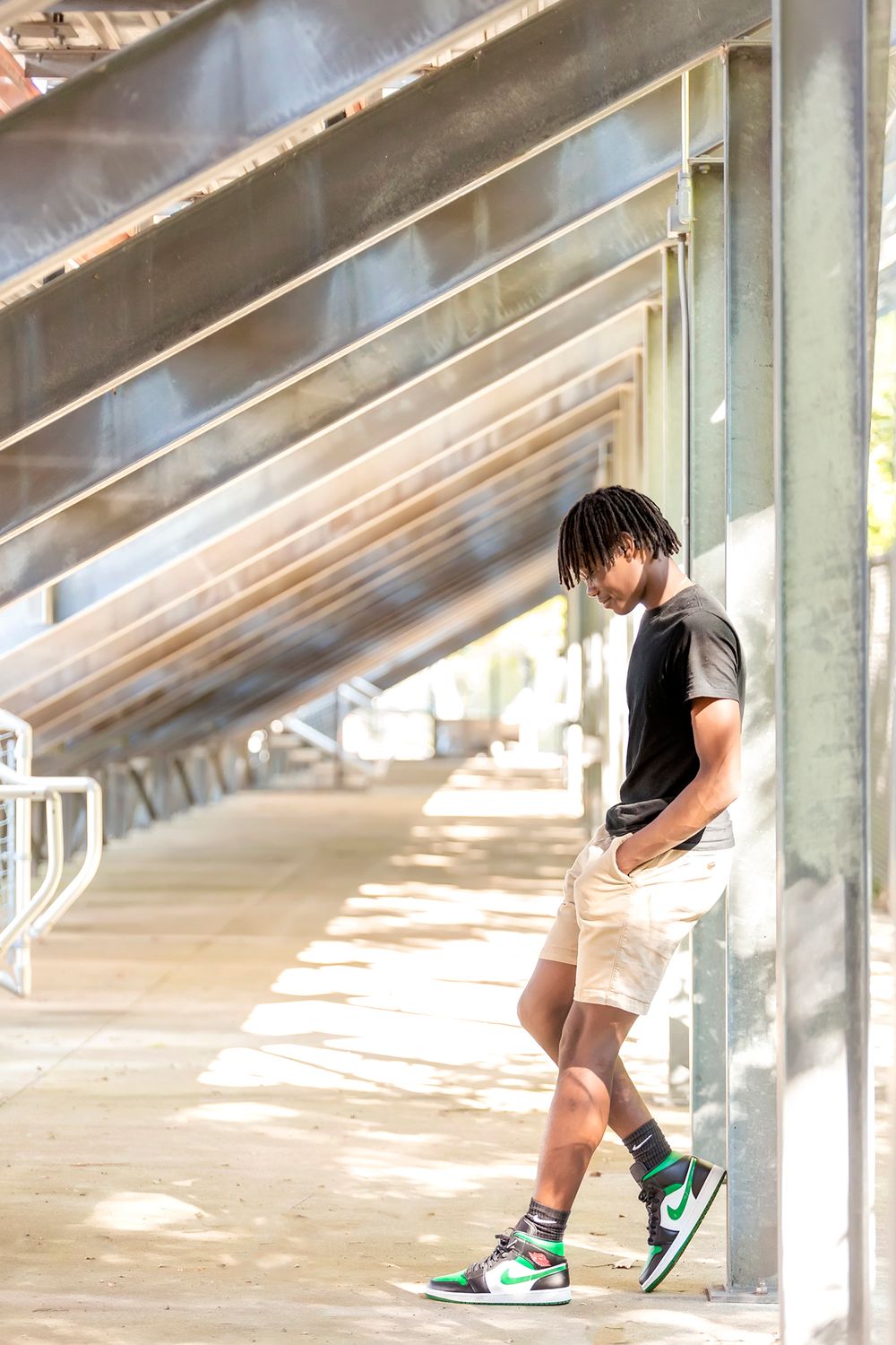 Silhouette of someone walking through an industrial space with dramatic shadows.