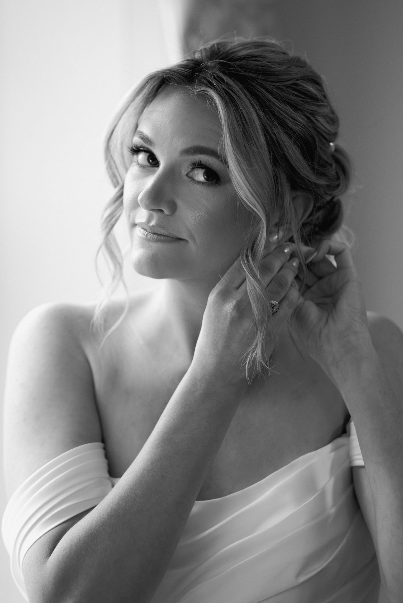 Black and white portrait of bride with romantic updo hairstyle.