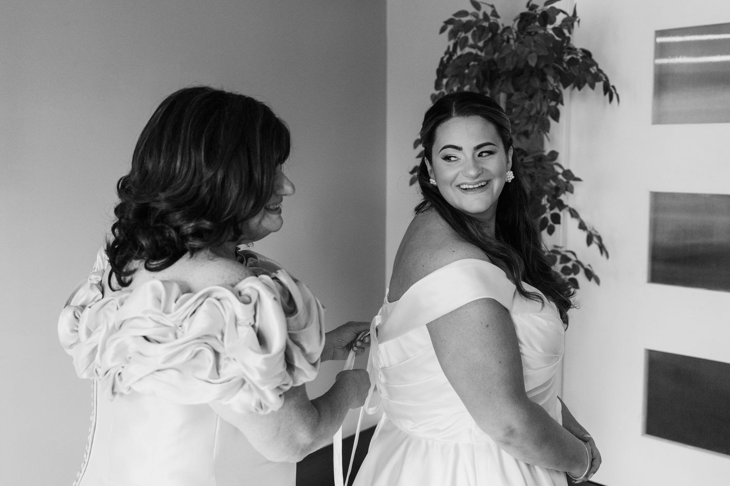 A series of black and white photos showing someone getting dressed in formal attire.