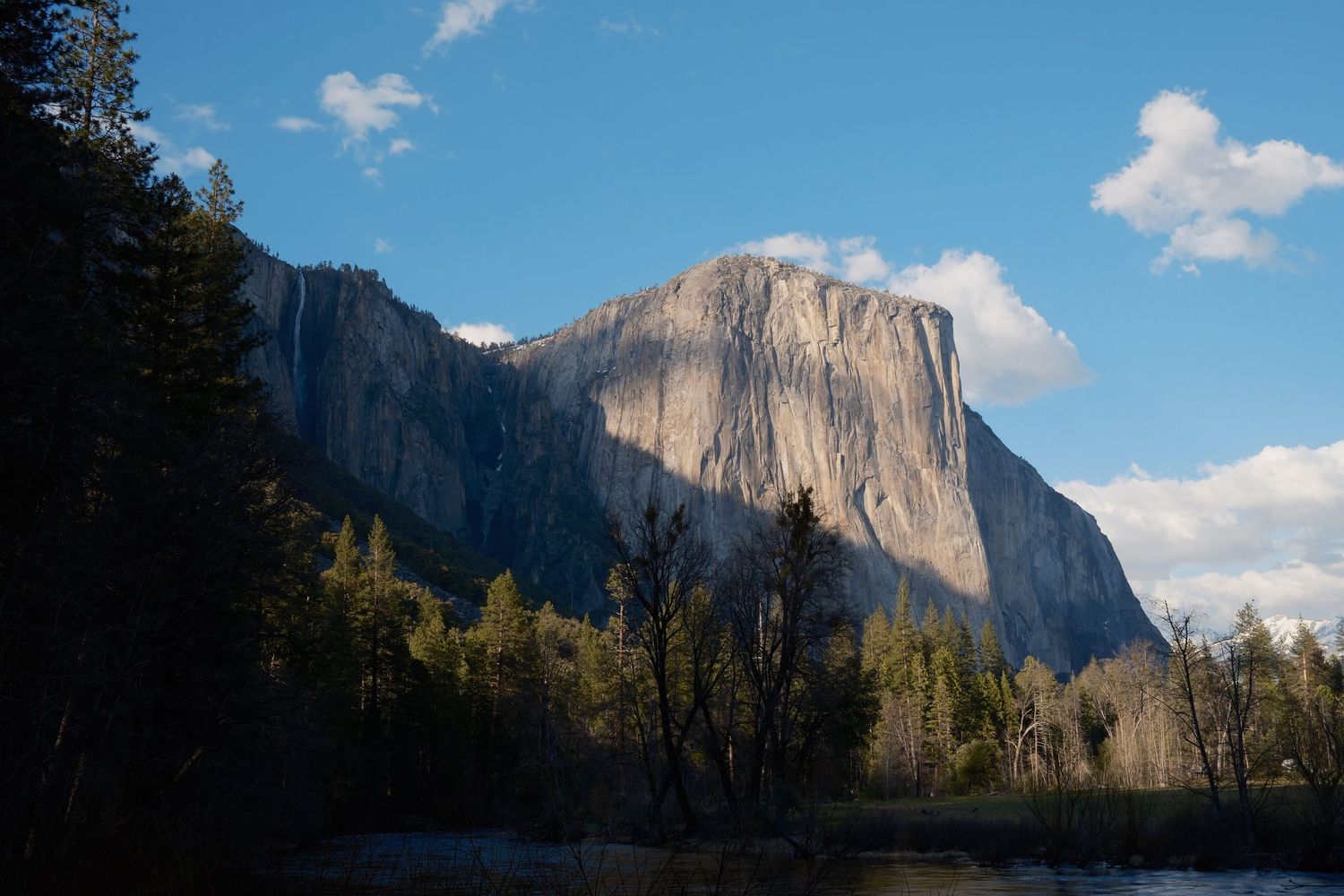 Panoramic view of El Capitan in Yosemite National Park under blue skies photographed by Gia Quilap.