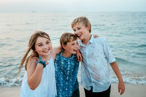 children laughing and playing at beach