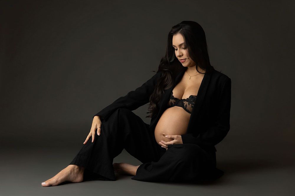 A series of artistic boudoir photos featuring a woman in black lingerie posing against a dark background.