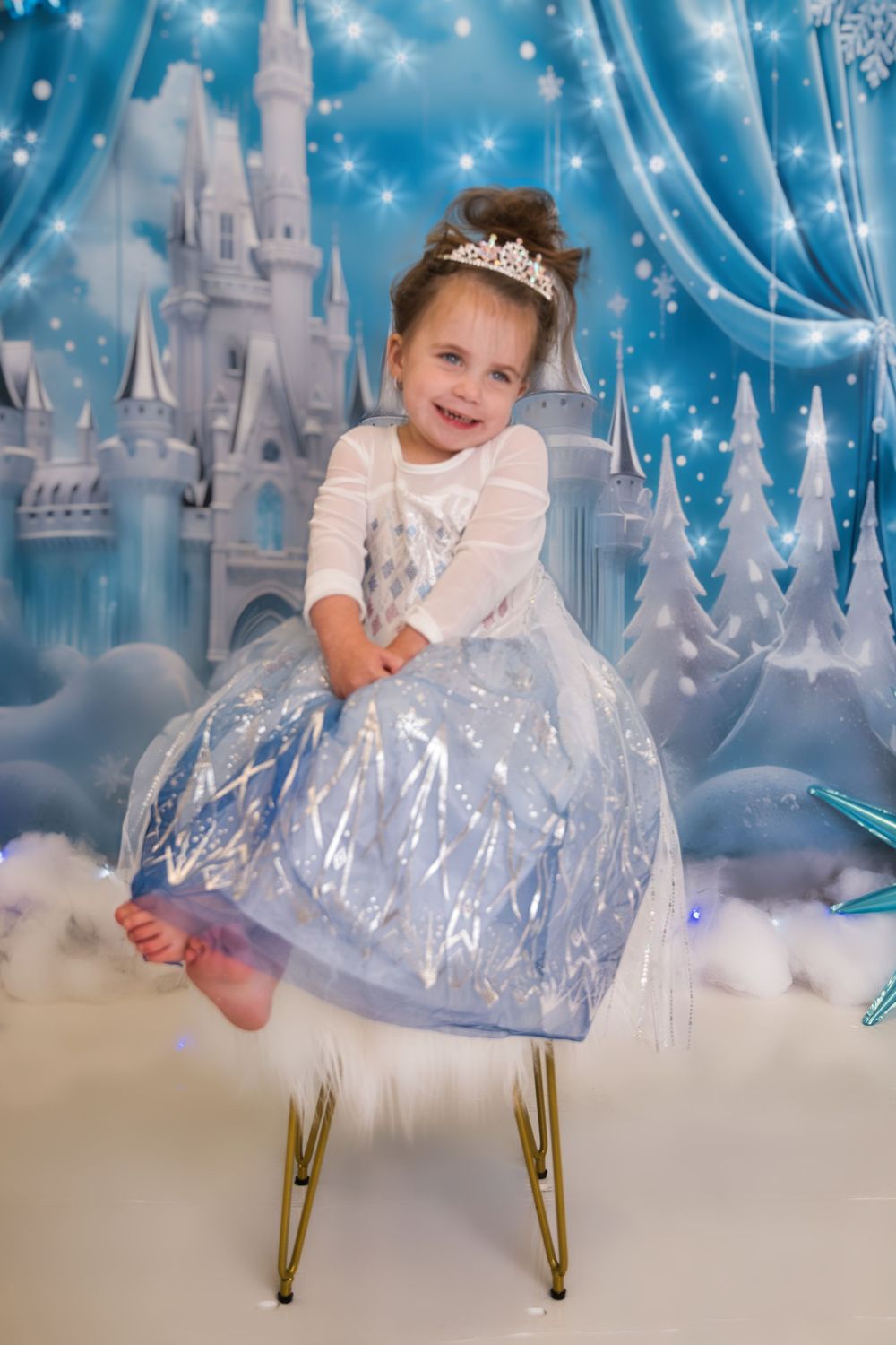 Four connected dreamy photos with sparkly blue castle backdrop showing a small person in a shimmery white dress and crown.