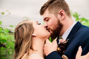 A couple shares a passionate kiss during their wedding photo session.
