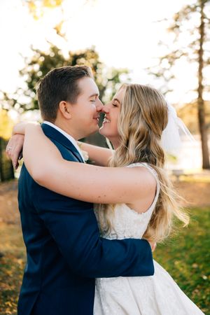 A loving embrace between newlyweds during golden hour sunset photography.