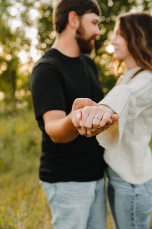Close-up series showing hands with engagement ring in golden sunset light.