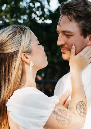 A romantic couple shares intimate moments during their sunset wedding photoshoot.