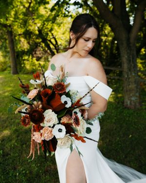 Elegant bridal bouquet featuring deep burgundy and white flowers with natural greenery.