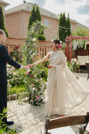 A joyful celebration moment during an outdoor backyard wedding ceremony.