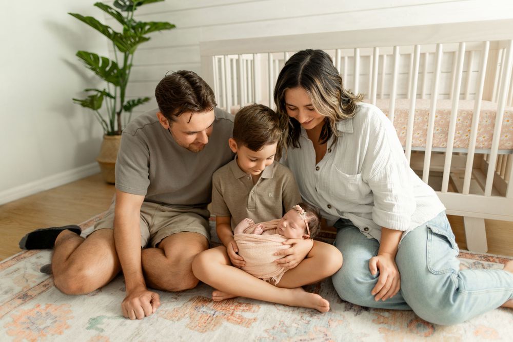 Natural lifestyle family photo session on cozy bed with neutral colors.