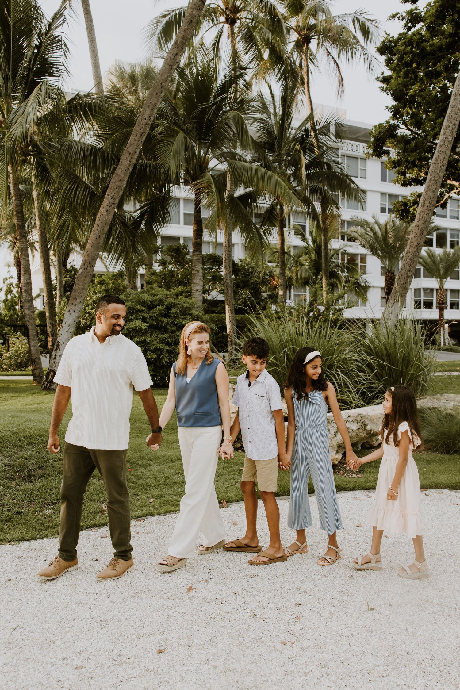 Golden hour summer family photos captured by Lindsay McDow Photography in front of Flagler Museum and in park by water on Palm Beach Island