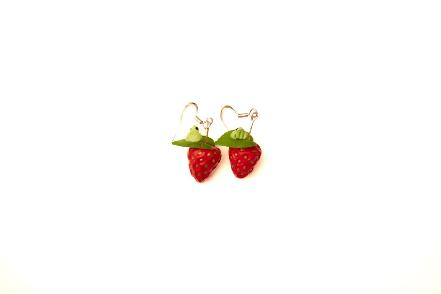 Two ripe red strawberries with green stems isolated on a white background.