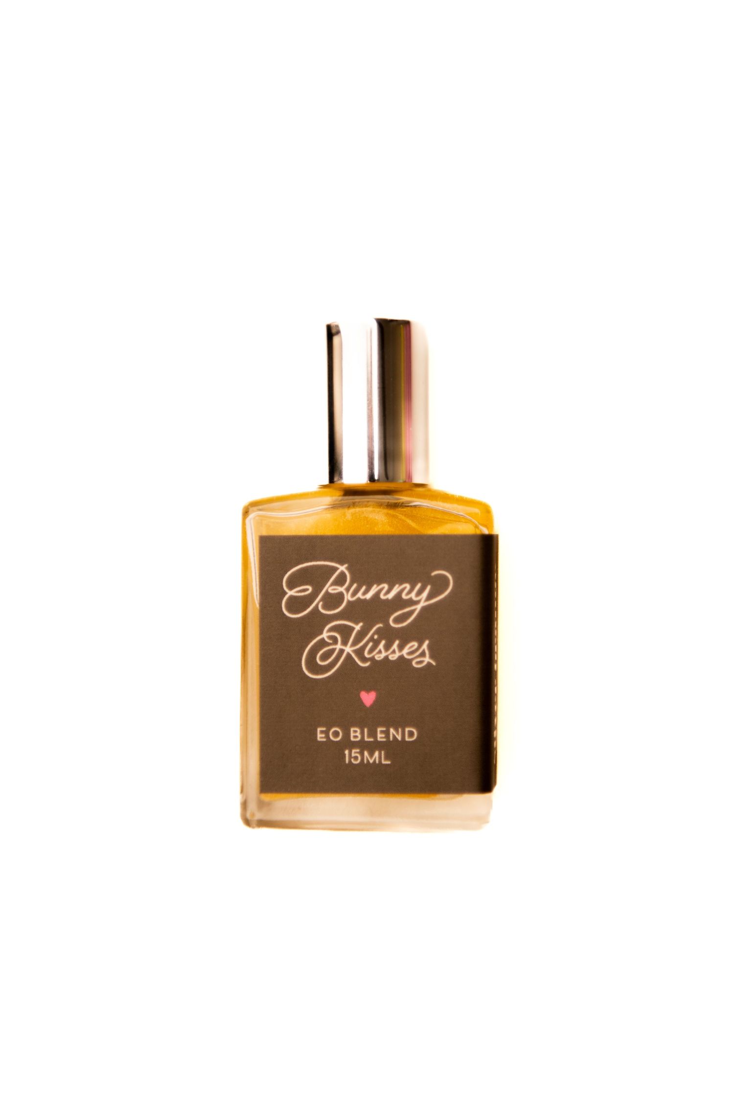 A brown labeled glass bottle of Bunny Kisses EO Blend perfume oil with a metallic cap against a white background.