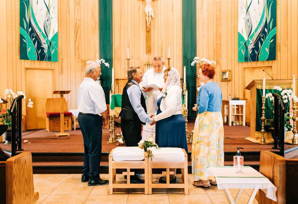 Older couple vow renewal standing in front of a church with their family, Nipomo, CA