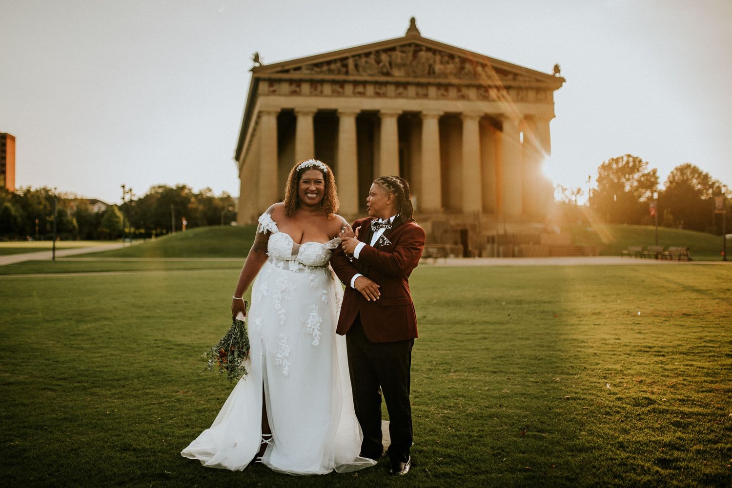 Same sex wedding couple in front of the parthenon in Nashville, Tennessee at sunset.
