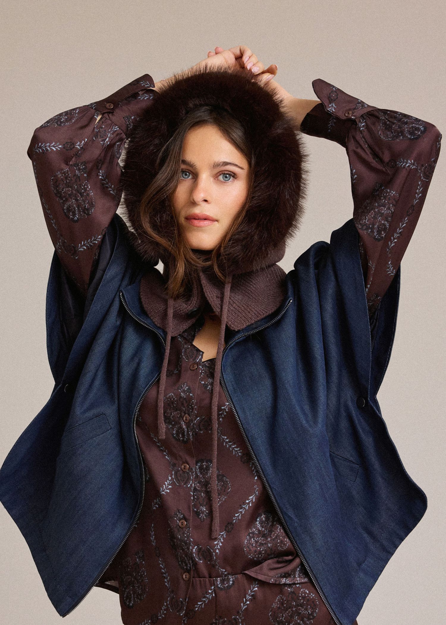 Fashion model wearing a navy blue coat with brown fur-trimmed collar shown in multiple poses against neutral background.