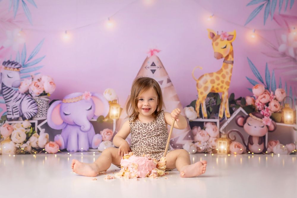Whimsical nursery themed setup with stuffed animals, lights, and decorative tent.