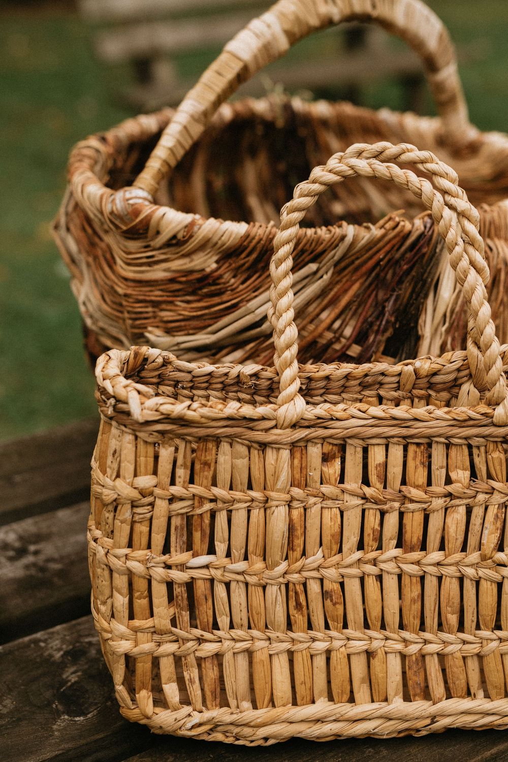 Close-up progression shots showing the detailed weaving process of a rustic wicker basket using natural materials.
