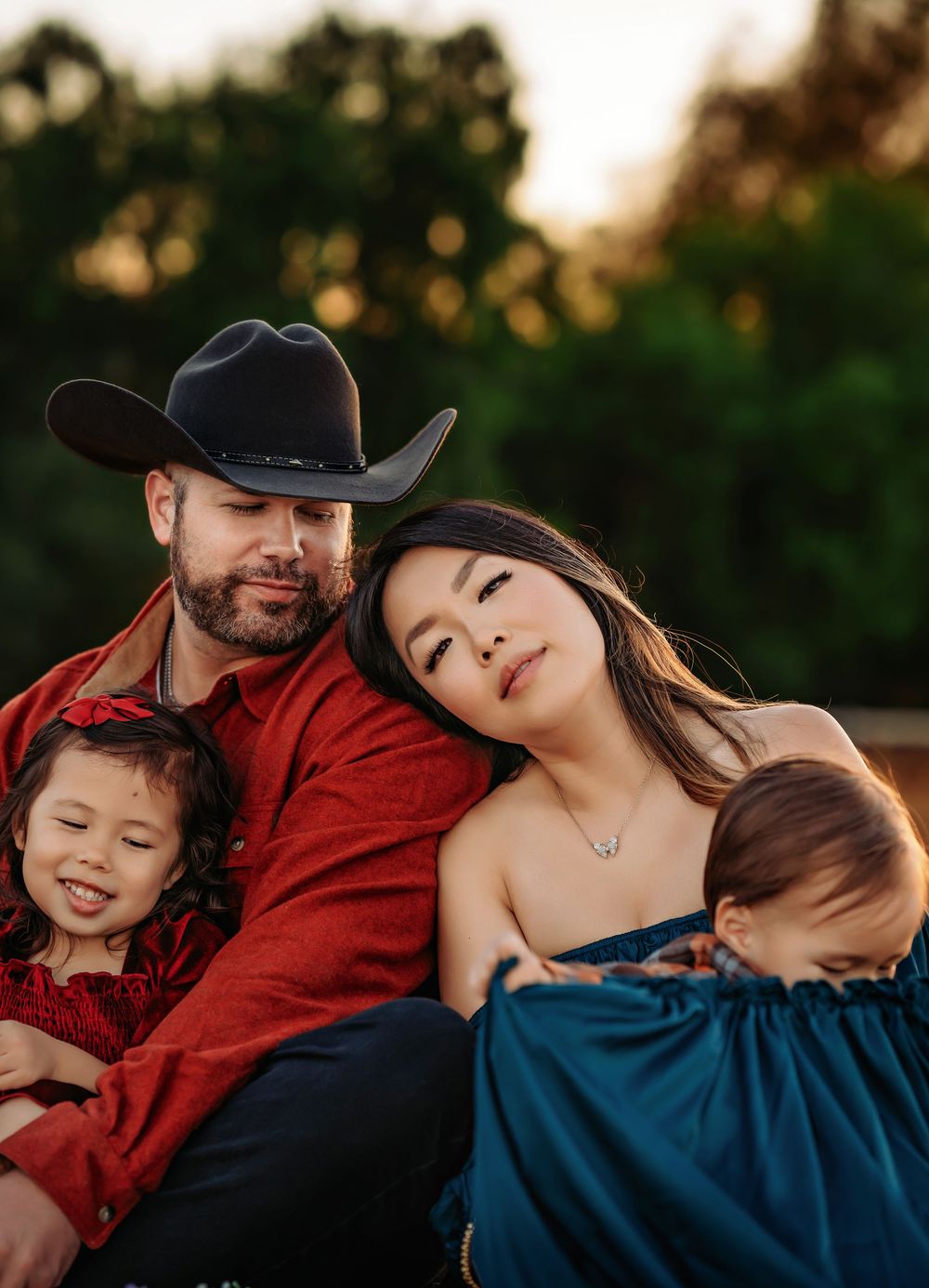 A couple wearing western attire shares tender moments in a sunset photo series against a natural outdoor backdrop.