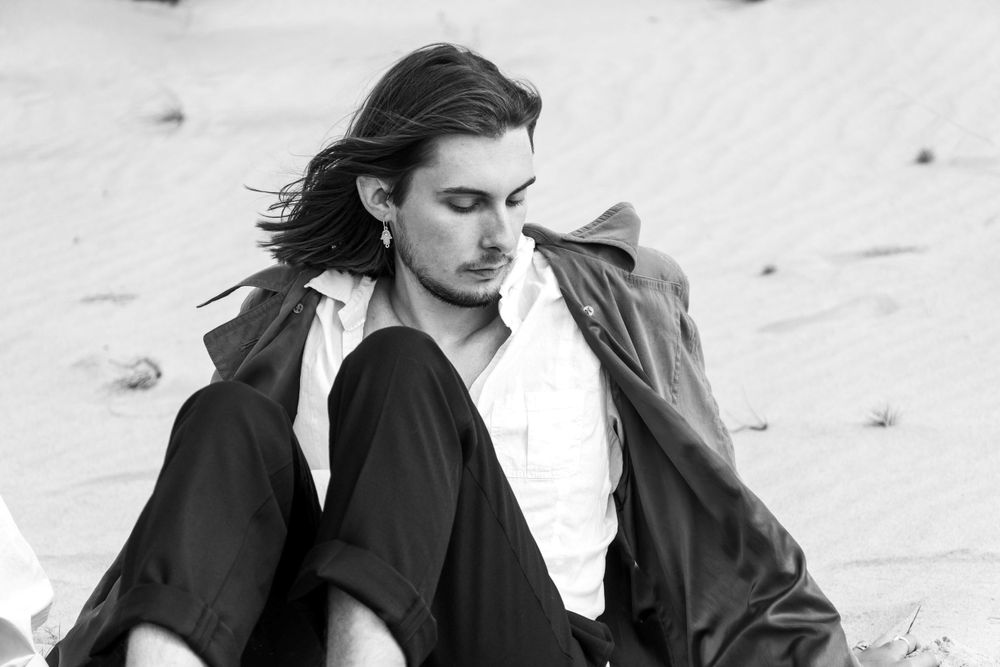 A man sitting at the seaside.