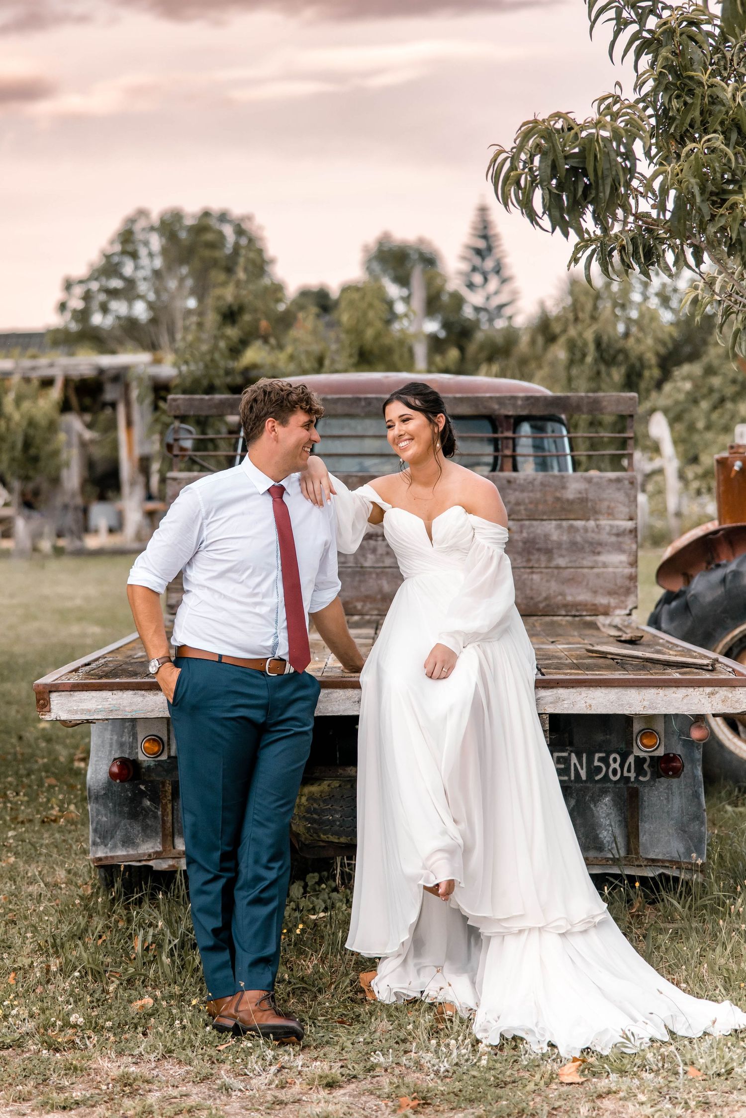 Bride and groom, with a greenscape background at Crab Farm Winery