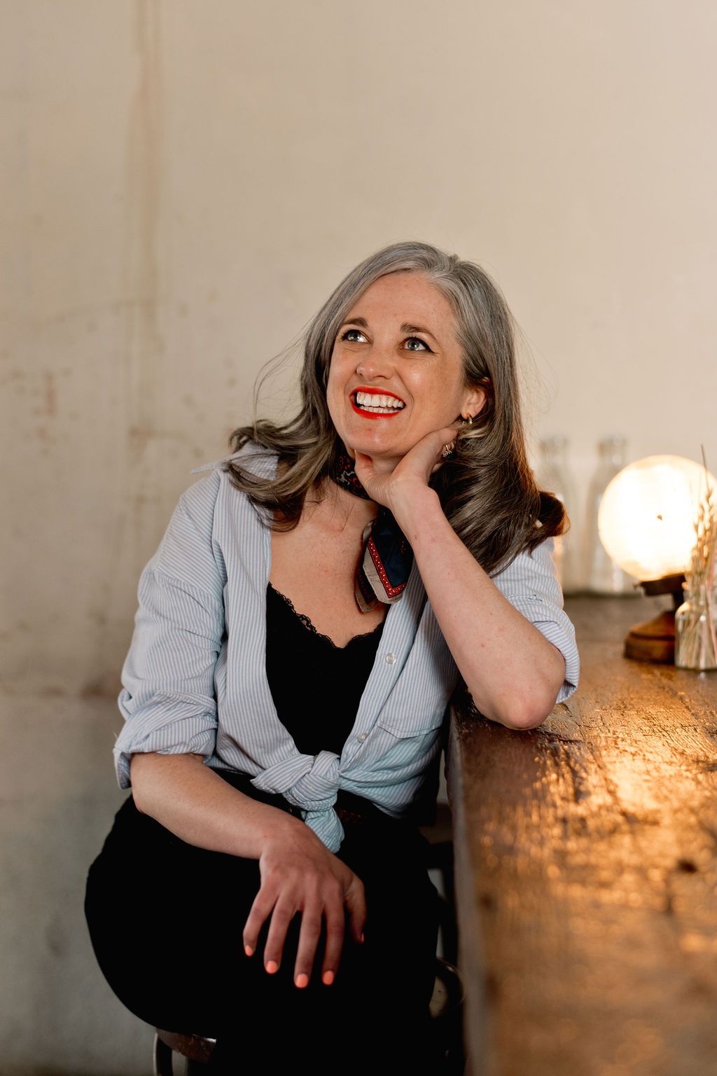 Black and white portrait of smiling woman with flowing hair.