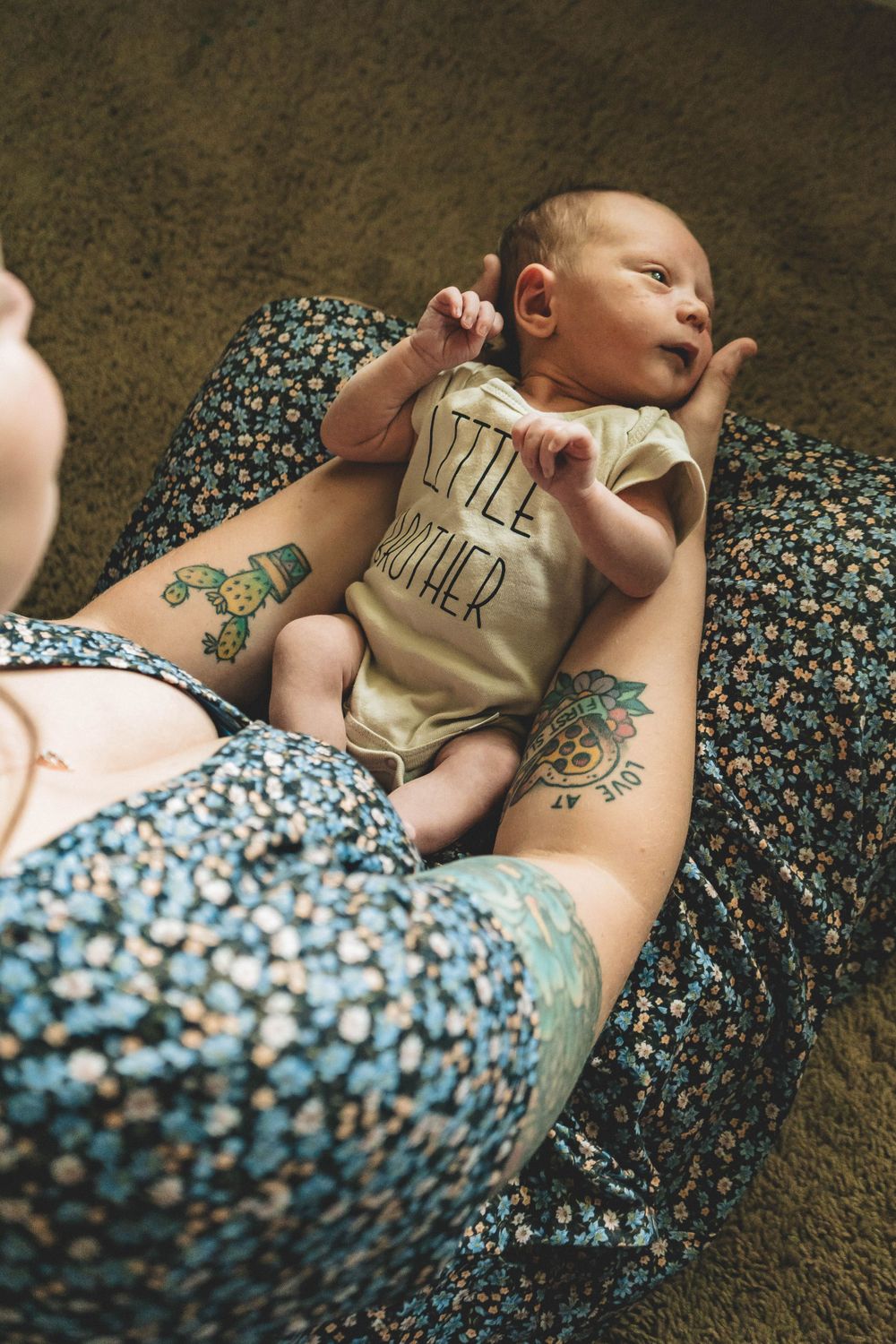 Baby giggling in mom’s arms during a sun-drenched family portrait session on the Space Coast.