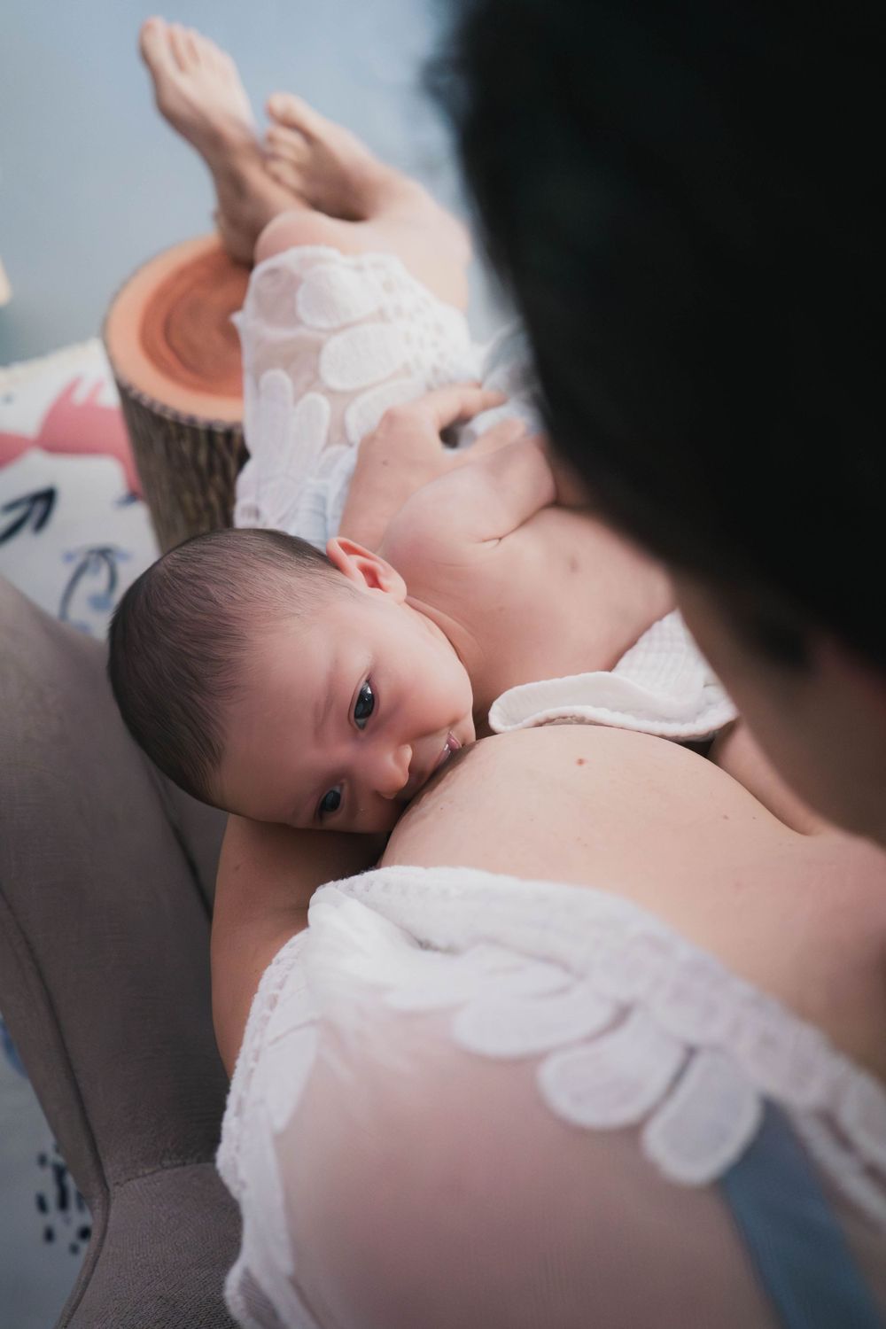 Connected, quiet newborn moments captured in your home with honesty and heart. Breastfeeding in the space coast florida