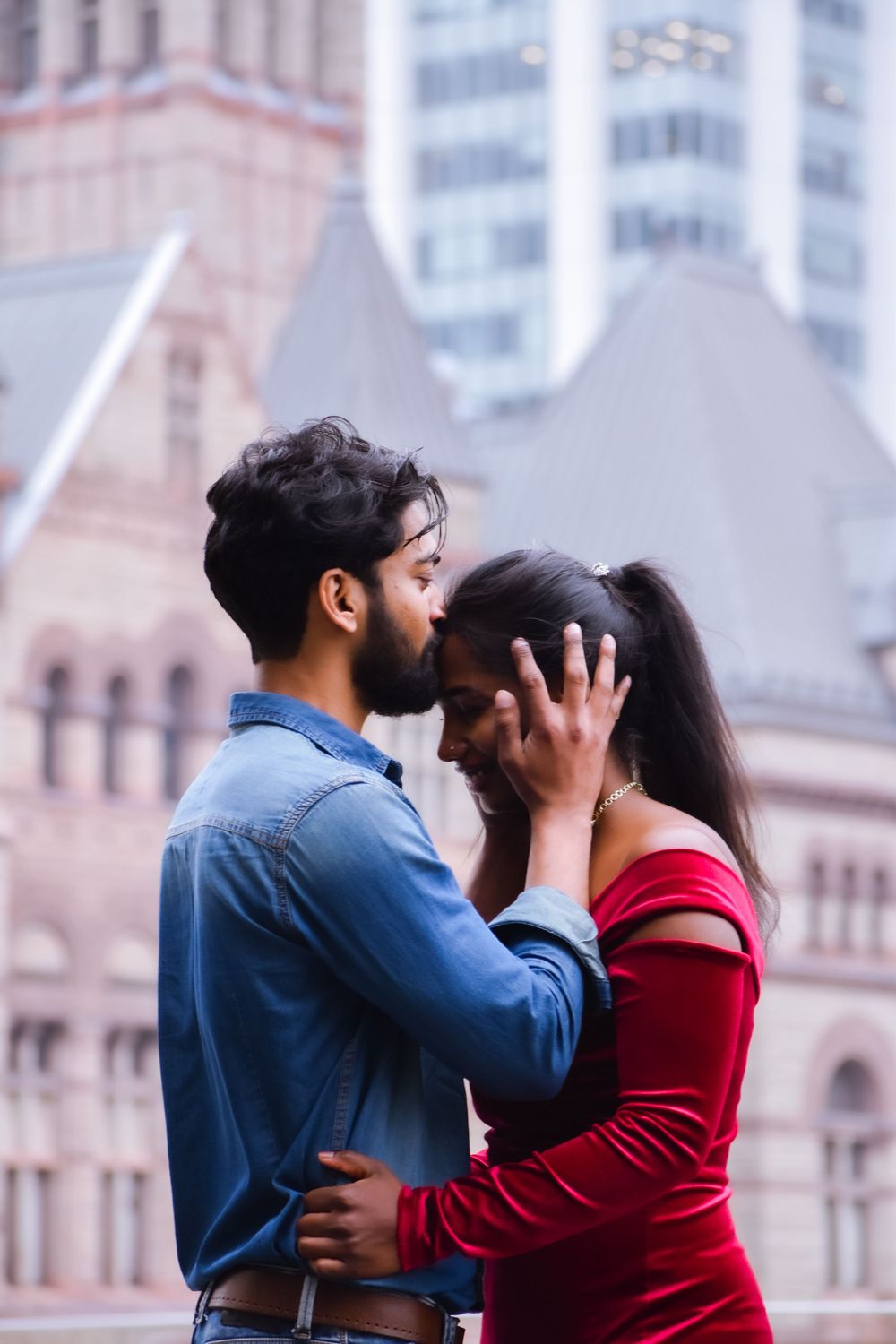 Romantic couple sharing an intimate moment in front of a historic building. Toronto GTA