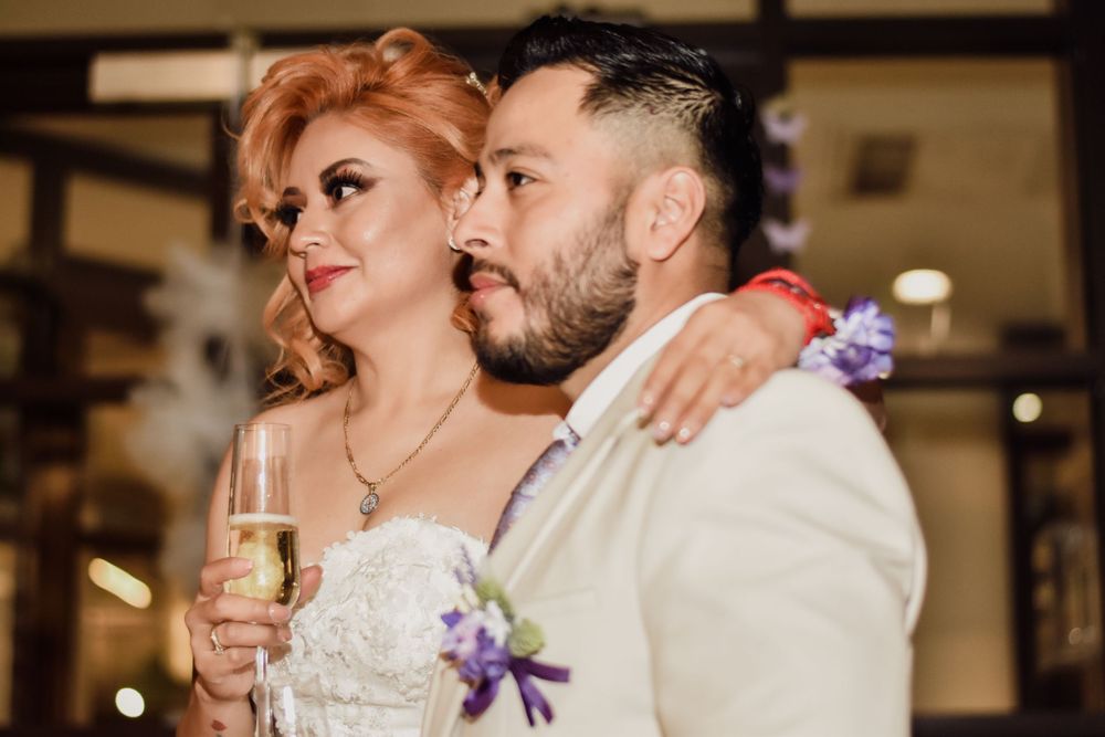 Bride and groom sharing a romantic moment at their wedding reception, bride holding champagne glass. Toronto GTA