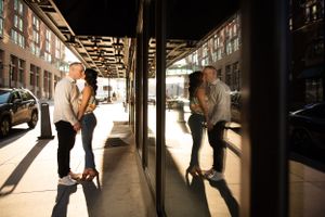 Creative urban engagement photo using window reflection and shadow play.