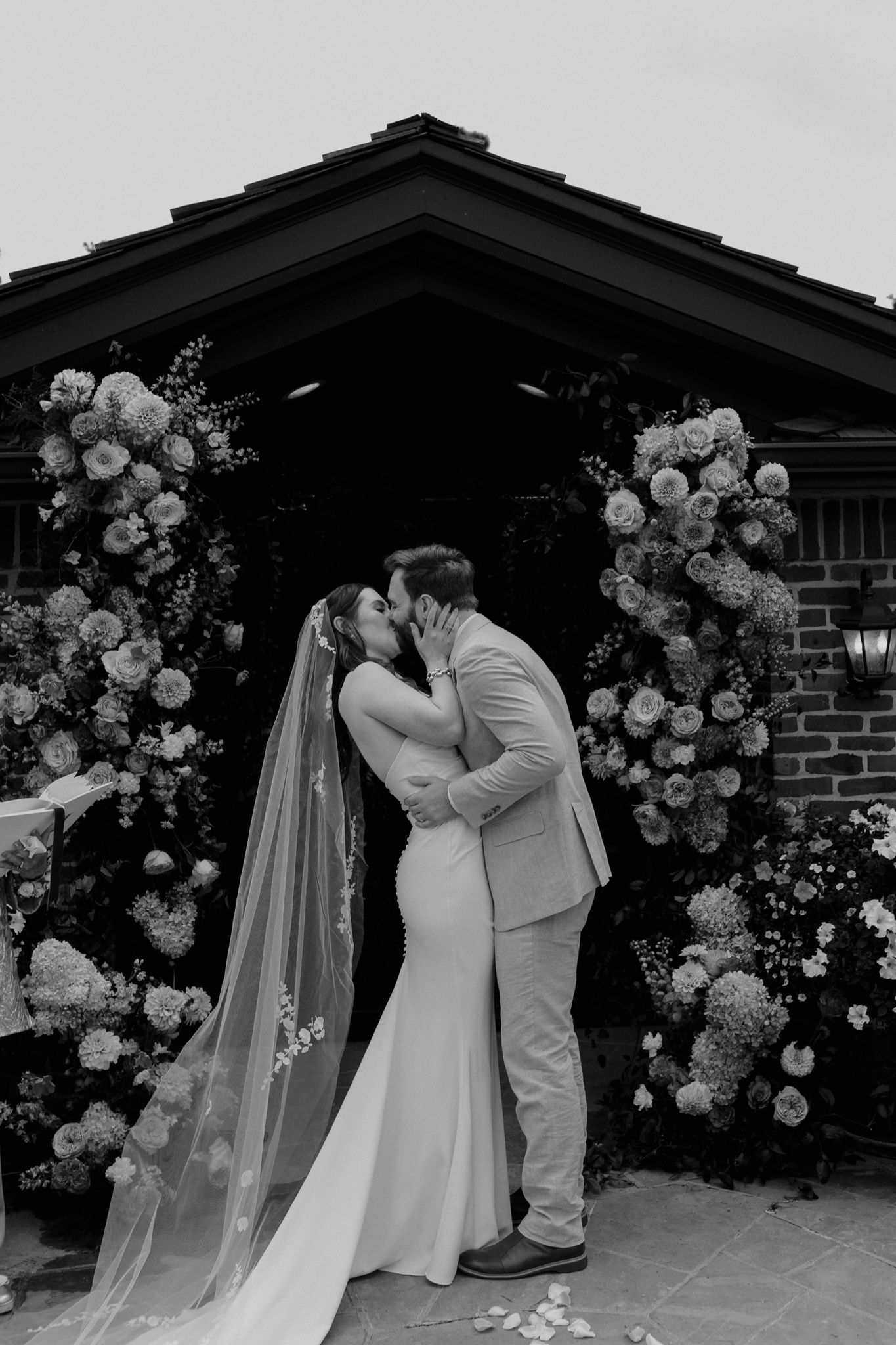Wedding ceremony under a floral arch decorated with white roses, Colorado