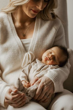 Newborn photography of a mom holding her new baby in Carmel, Indiana